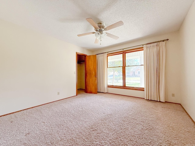1908 Honeysuckle Dr, Mountain Home, AR 72653 - unfurnished room with light colored carpet, a ceiling fan, a textured ceiling, and baseboards