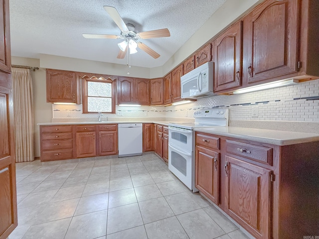 1908 Honeysuckle Dr, Mountain Home, AR 72653 - kitchen with white appliances, a textured ceiling, light countertops, backsplash, and a ceiling fan