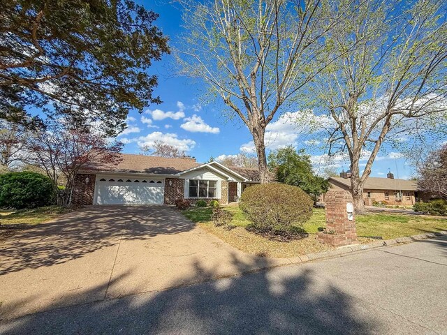1908 Honeysuckle Dr, Mountain Home, AR 72653 - single story home with an attached garage, concrete driveway, and brick siding