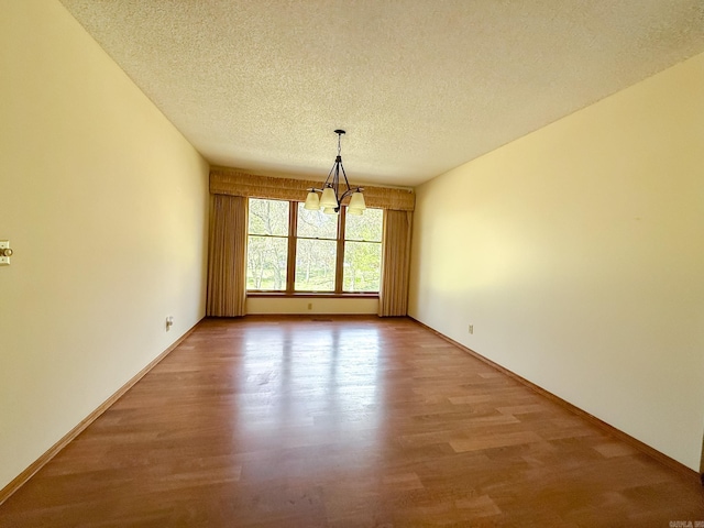 1908 Honeysuckle Dr, Mountain Home, AR 72653 - unfurnished dining area with a chandelier, light wood-type flooring, a textured ceiling, and baseboards