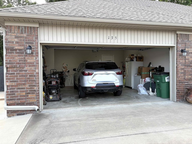 135 Meadow Dr, Beebe, AR 72012 - garage featuring concrete driveway and freestanding refrigerator