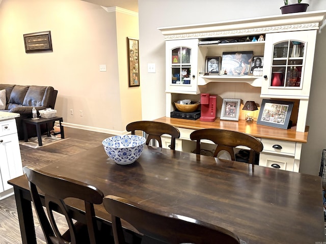 135 Meadow Dr, Beebe, AR 72012 - dining area featuring baseboards, dark wood-type flooring, and crown molding