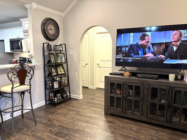 135 Meadow Dr, Beebe, AR 72012 - living room featuring crown molding, wood finished floors, lofted ceiling, arched walkways, and baseboards
