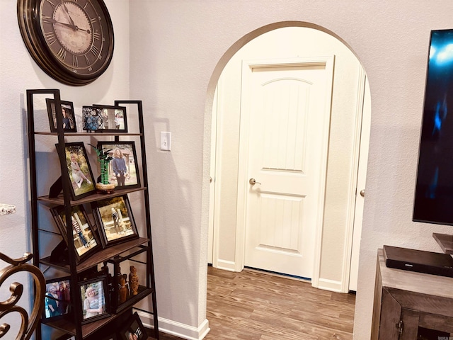 135 Meadow Dr, Beebe, AR 72012 - hallway with arched walkways, wood finished floors, and baseboards