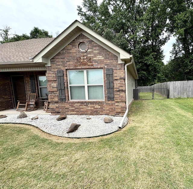 135 Meadow Dr, Beebe, AR 72012 - view of home's exterior with a shingled roof and brick siding
