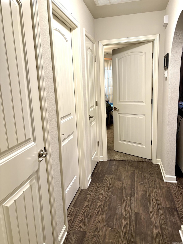 135 Meadow Dr, Beebe, AR 72012 - corridor with dark wood-style floors, arched walkways, and baseboards