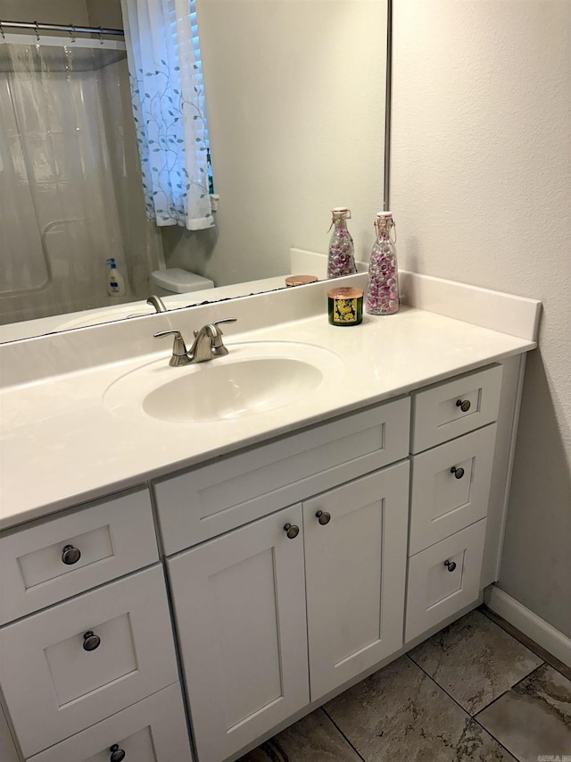 135 Meadow Dr, Beebe, AR 72012 - bathroom featuring vanity, curtained shower, marble look tile flooring, and baseboards