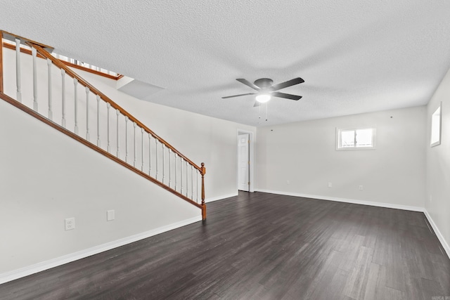 1214 Sammy St, Mountain Home, AR 72653 - unfurnished living room featuring wood finished floors, stairway, a ceiling fan, a textured ceiling, and baseboards