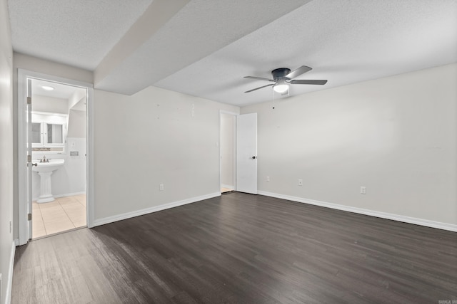 1214 Sammy St, Mountain Home, AR 72653 - empty room featuring dark wood finished floors, a ceiling fan, baseboards, and a textured ceiling