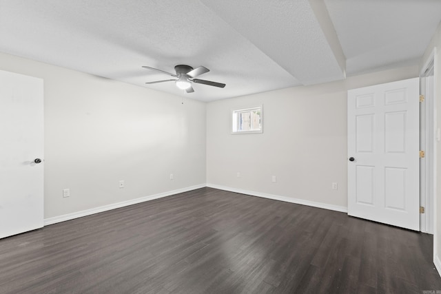 1214 Sammy St, Mountain Home, AR 72653 - empty room featuring ceiling fan, dark wood finished floors, baseboards, and a textured ceiling