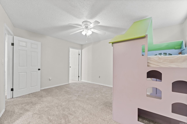 1214 Sammy St, Mountain Home, AR 72653 - unfurnished bedroom with carpet flooring, a textured ceiling, baseboards, and a ceiling fan