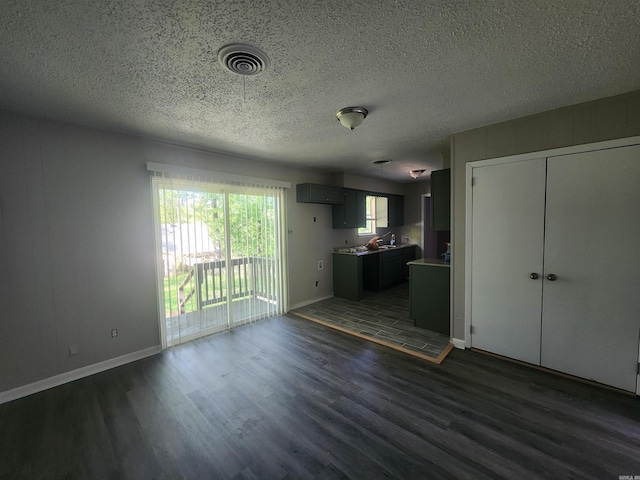 8 W Windsor Dr, Little Rock, AR 72209 - unfurnished living room with dark wood-style floors, a textured ceiling, and baseboards