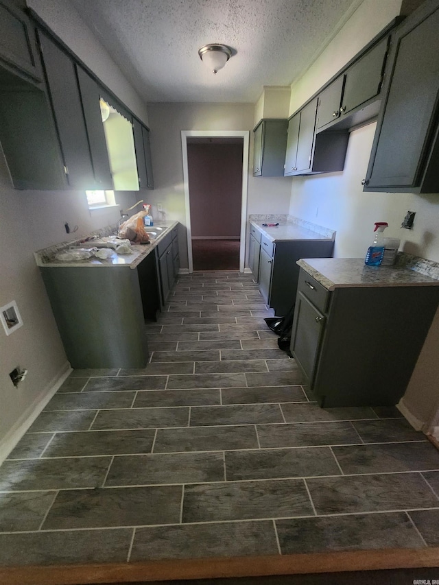 8 W Windsor Dr, Little Rock, AR 72209 - kitchen with a textured ceiling, baseboards, a sink, and light countertops