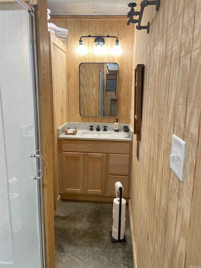 630 Cliffview Dr, Quitman, AR 72131 - bathroom featuring a shower stall, vanity, wooden walls, and concrete flooring