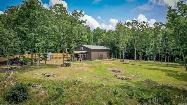 630 Cliffview Dr, Quitman, AR 72131 - view of yard with an outdoor structure, a wooded view, and a fire pit