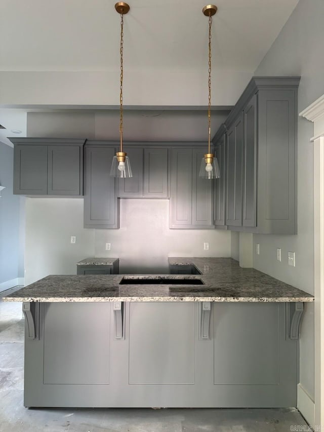 1505 S State, Little Rock, AR 72202 - kitchen featuring a peninsula, dark stone countertops, gray cabinets, and a breakfast bar area