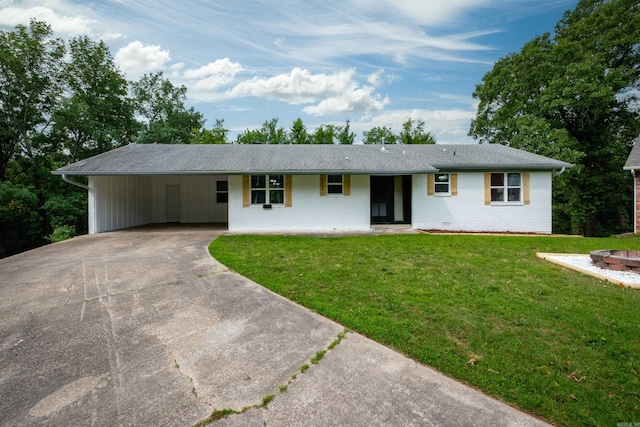 4605 N Cedar, North Little Rock, AR 72116 - ranch-style house with driveway, a front yard, an attached carport, and brick siding
