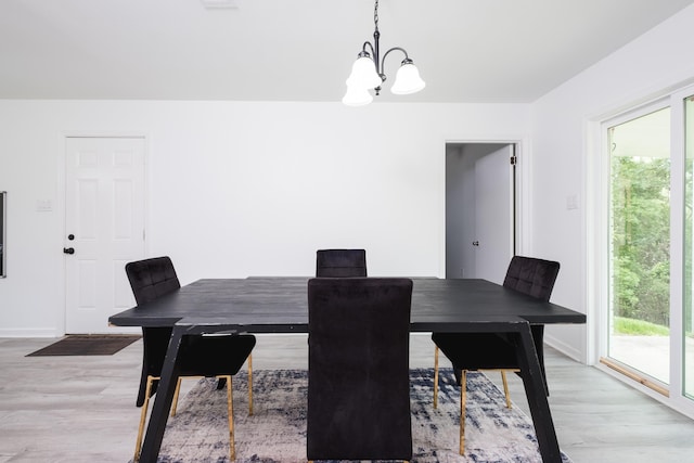 4605 N Cedar, North Little Rock, AR 72116 - dining room with a chandelier, light wood-type flooring, and baseboards