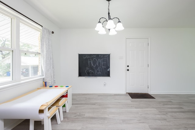4605 N Cedar, North Little Rock, AR 72116 - dining area featuring a chandelier, light wood-style flooring, and baseboards