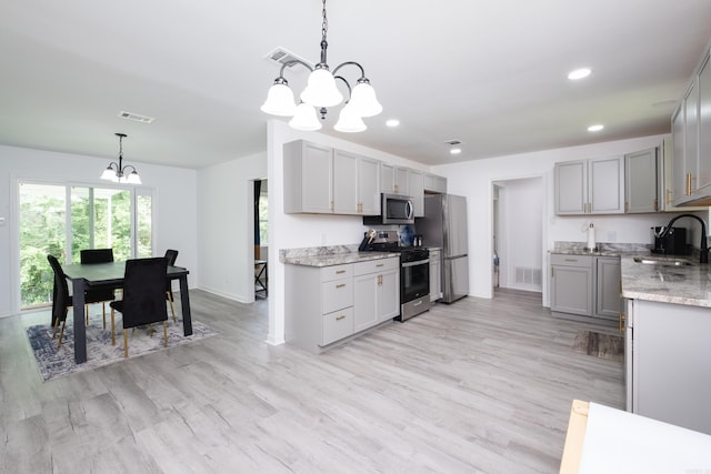 4605 N Cedar, North Little Rock, AR 72116 - kitchen featuring a chandelier, stainless steel appliances, a sink, light stone counters, and recessed lighting