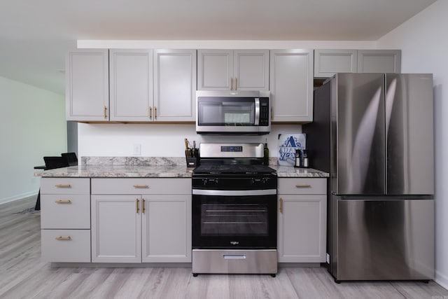 4605 N Cedar, North Little Rock, AR 72116 - kitchen with appliances with stainless steel finishes, light wood-style flooring, and light stone counters