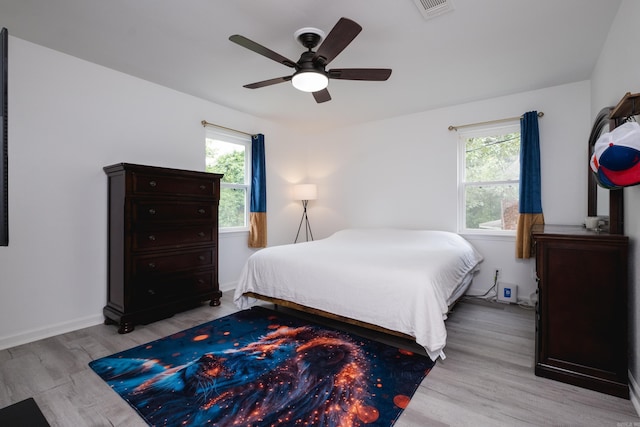 4605 N Cedar, North Little Rock, AR 72116 - bedroom with multiple windows, light wood-type flooring, ceiling fan, and baseboards