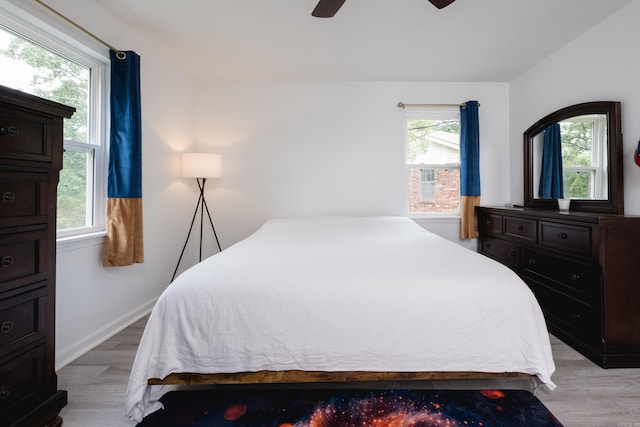 4605 N Cedar, North Little Rock, AR 72116 - bedroom with light wood-type flooring, multiple windows, a ceiling fan, and baseboards