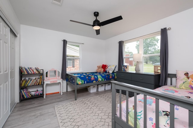 4605 N Cedar, North Little Rock, AR 72116 - bedroom with light wood finished floors, a closet, and ceiling fan