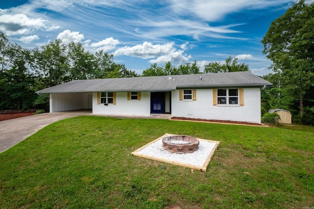 4605 N Cedar, North Little Rock, AR 72116 - single story home featuring a fire pit, concrete driveway, a front lawn, and brick siding