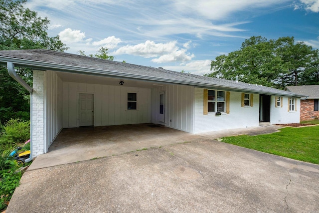 4605 N Cedar, North Little Rock, AR 72116 - ranch-style home featuring concrete driveway, a carport, brick siding, and a front yard