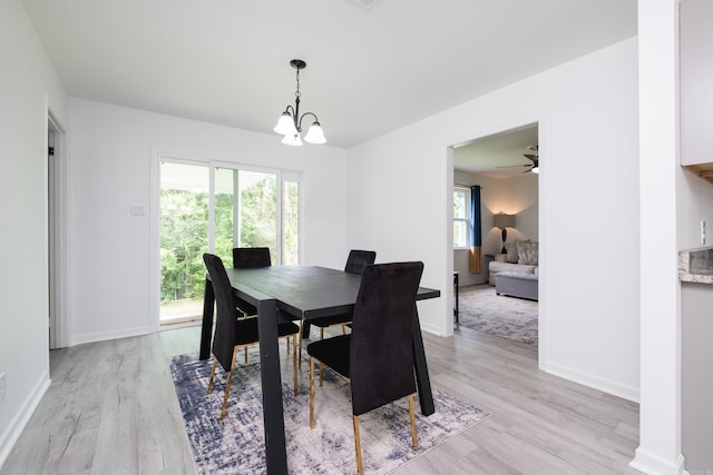 4605 N Cedar, North Little Rock, AR 72116 - dining space featuring light wood-style floors, baseboards, and a chandelier