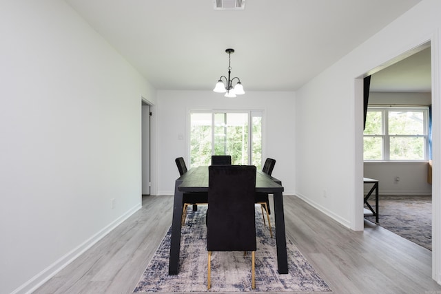4605 N Cedar, North Little Rock, AR 72116 - dining space featuring light wood finished floors, a chandelier, and baseboards