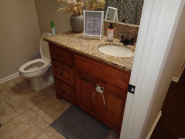 21 Sanibel Cv, Little Rock, AR 72210 - bathroom with vanity, toilet, tile patterned floors, and baseboards