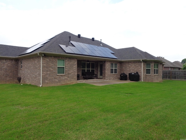 21 Sanibel Cv, Little Rock, AR 72210 - rear view of property featuring a patio area, roof mounted solar panels, brick siding, and roof with shingles