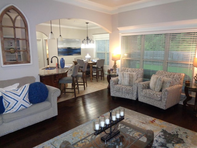 21 Sanibel Cv, Little Rock, AR 72210 - living area featuring hardwood / wood-style flooring, arched walkways, ornamental molding, and a chandelier