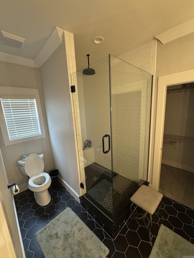 1927 College Ave, Conway, AR 72034 - full bathroom featuring toilet, a shower stall, tile patterned floors, baseboards, and a walk in closet