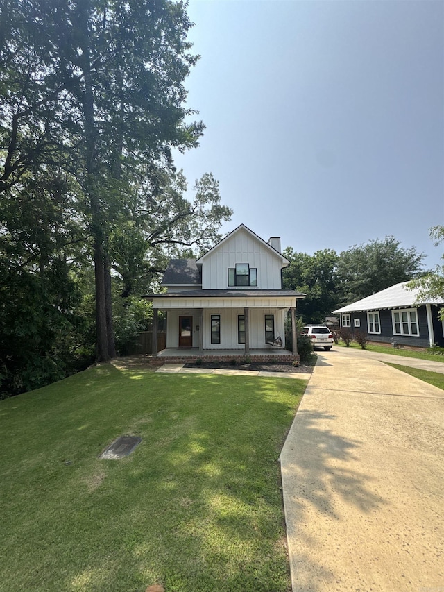 1927 College Ave, Conway, AR 72034 - modern farmhouse style home featuring covered porch, board and batten siding, driveway, a chimney, and a front lawn