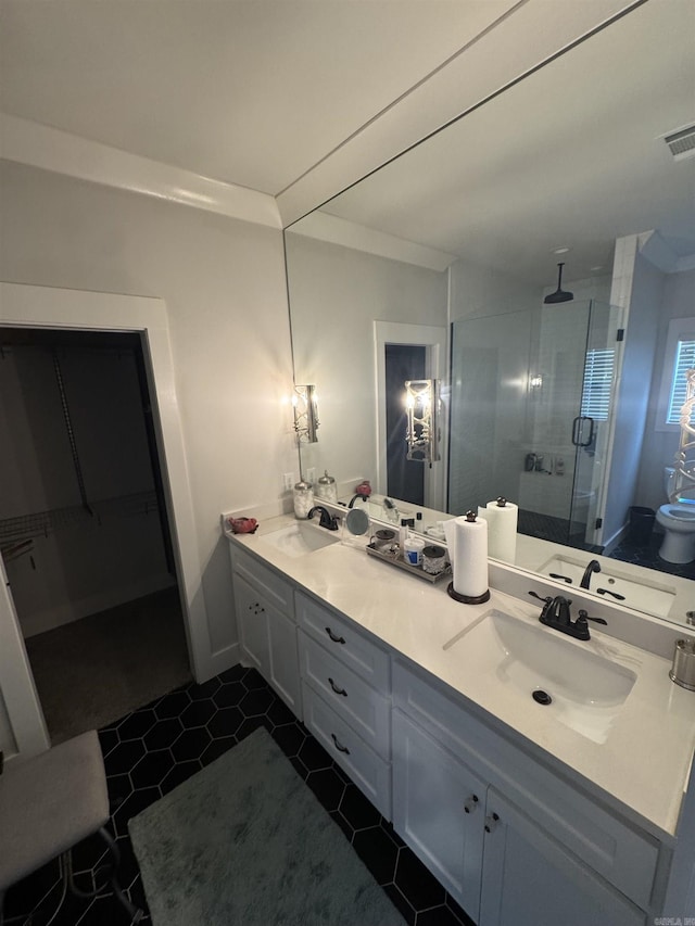 1927 College Ave, Conway, AR 72034 - full bath featuring a shower stall, double vanity, tile patterned flooring, and a spacious closet