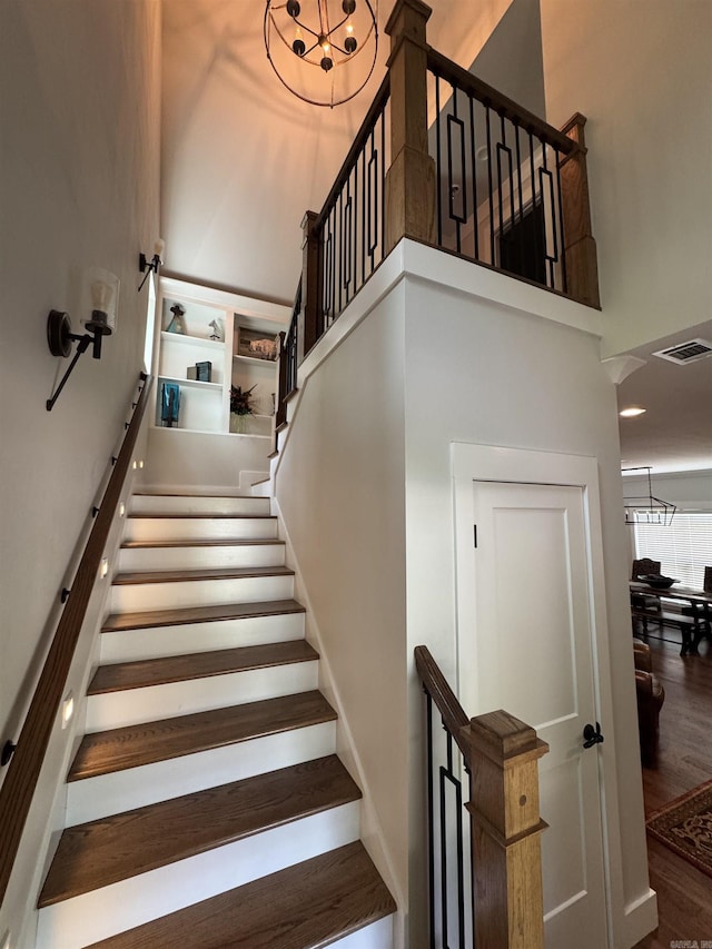 1927 College Ave, Conway, AR 72034 - stairway featuring a towering ceiling and wood finished floors
