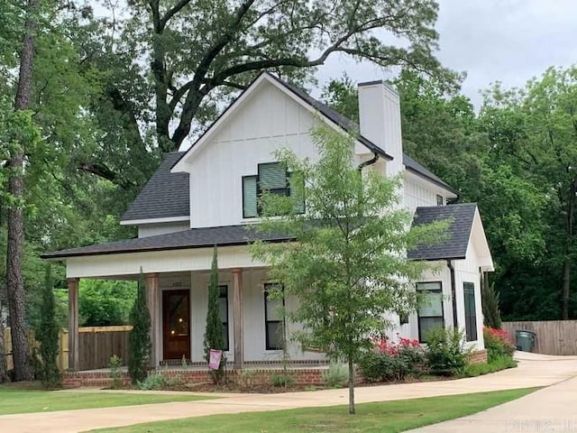 1927 College Ave, Conway, AR 72034 - modern farmhouse style home featuring a porch, a chimney, a shingled roof, and board and batten siding