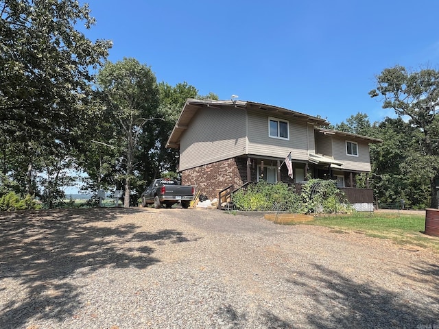 23 Bryant Ave, Oppelo, AR 72110 - view of front facade with driveway and brick siding
