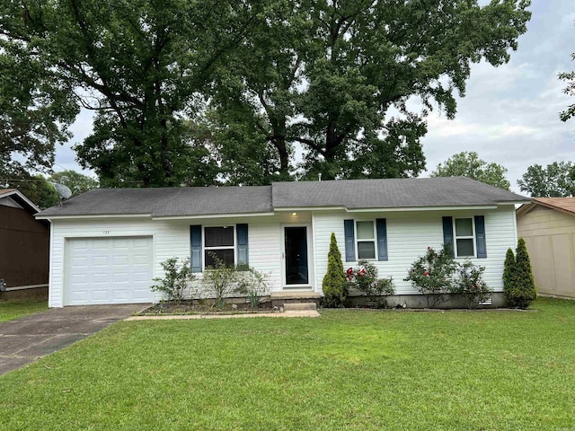 ranch-style home with driveway, an attached garage, and a front lawn