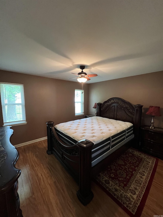 bedroom with wood finished floors, ceiling fan, and baseboards