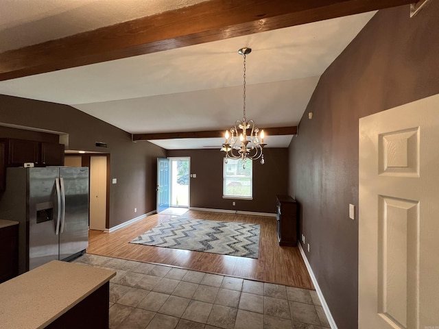 dining area featuring baseboards, a chandelier, and light tile patterned floors