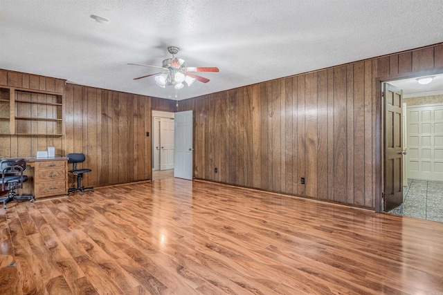 4204 Fox Hill Rd, North Little Rock, AR 72116 - unfurnished office featuring a ceiling fan, wood finished floors, wood walls, a textured ceiling, and crown molding