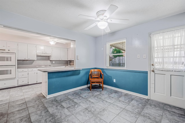 4204 Fox Hill Rd, North Little Rock, AR 72116 - kitchen with white appliances, ceiling fan, white cabinetry, a textured ceiling, and light countertops