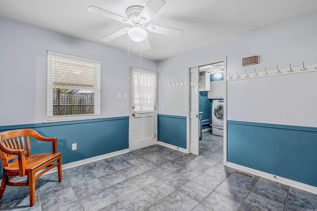 4204 Fox Hill Rd, North Little Rock, AR 72116 - living area with a textured ceiling, washer / clothes dryer, a wainscoted wall, and ceiling fan