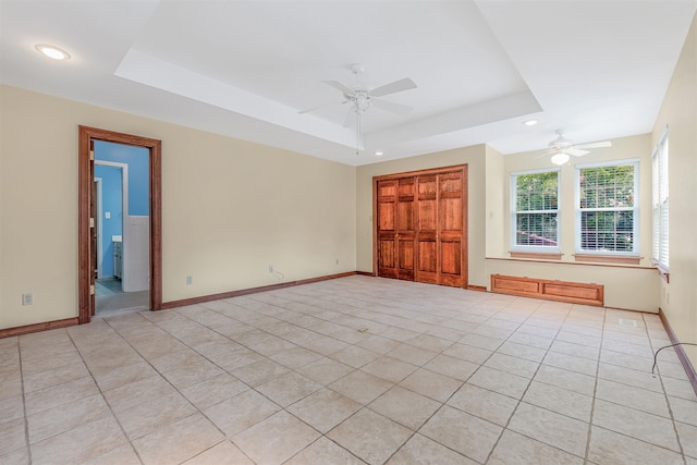 4204 Fox Hill Rd, North Little Rock, AR 72116 - empty room with ceiling fan, a tray ceiling, light tile patterned floors, recessed lighting, and baseboards