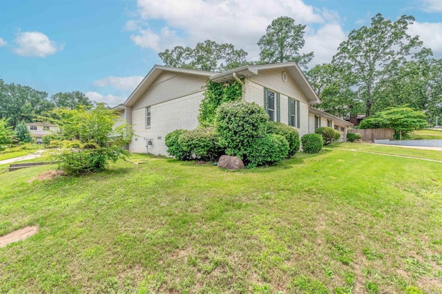 4204 Fox Hill Rd, North Little Rock, AR 72116 - view of side of property featuring a lawn and brick siding