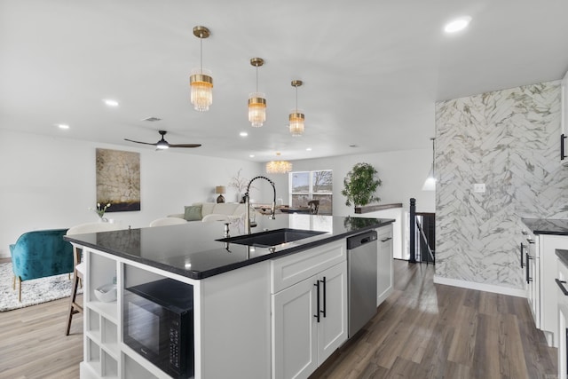 7 Buttermilk Rd, Little Rock, AR 72227 - kitchen featuring stainless steel dishwasher, a sink, dark countertops, dark wood-style floors, and a ceiling fan